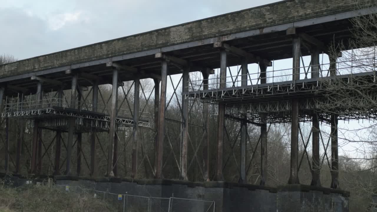 Old disused railway bridge viaduct wide panning shot