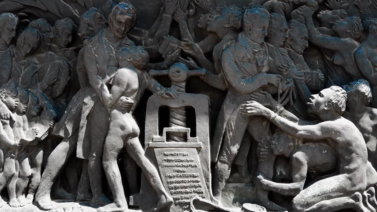 Stone engraved relief depicting Wilberforce and the freedom from slavery