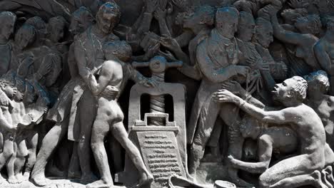 stone engraved relief depicting wilberforce and the freedom from slavery