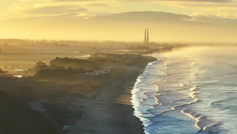 Moss Landing Powerplant Twin Towers warm golden sunrise morning mist seafog California aerial drone Sunset State Beach Pajaro Dunes Santa Cruz Manresa waves Monterey Bay Pacific Ocean static