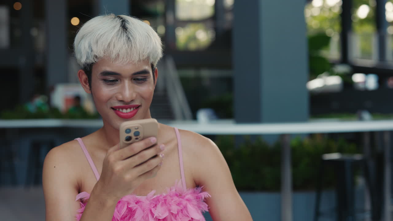 Man using mobile phone outdoors in a cafe