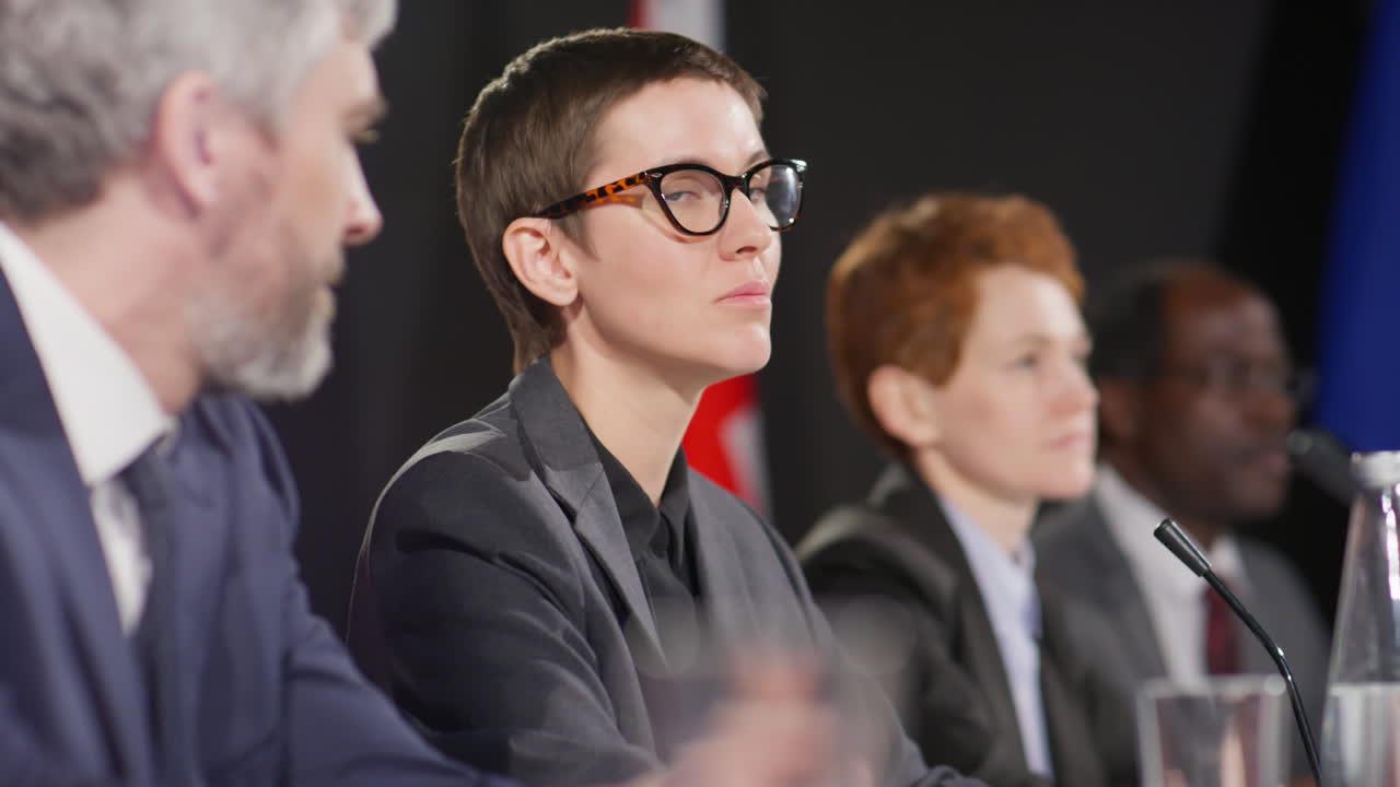 Young Female Diplomat Holding Speech at Press Conference