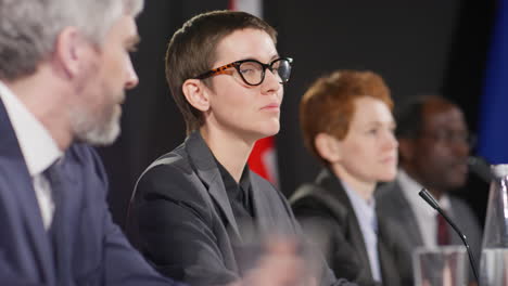 young female diplomat holding speech at press conference