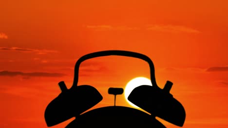 time lapse of silhouette of alarm clock ringing at sunrise time in the morning. professional shot in 4k resolution.