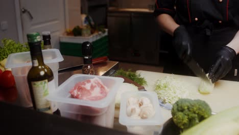 chef chopping cabbage and other vegetables