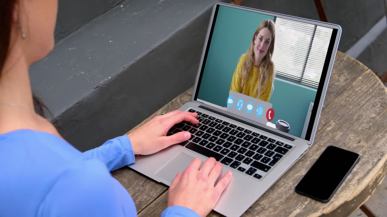 Caucasian woman using laptop on video call with female colleague working from home