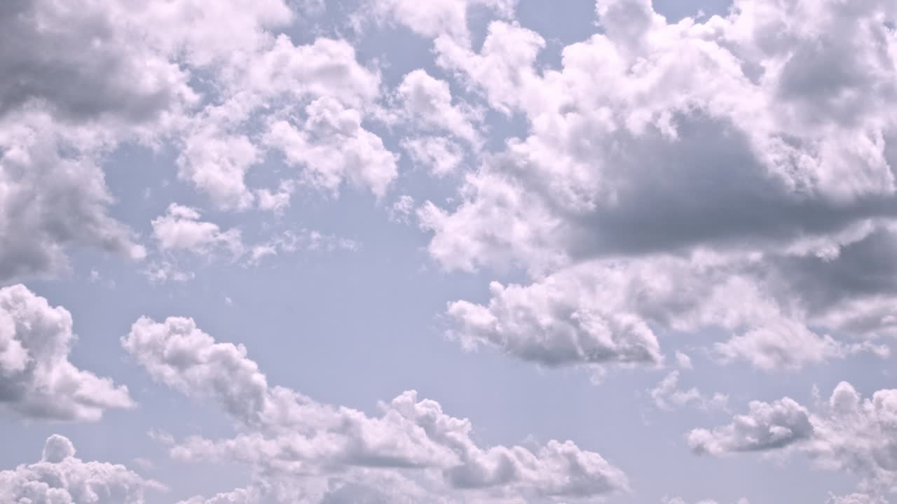A stunning timelapse captures post-storm clouds rolling over Indiana, with dramatic gray and white formations against a soft blue sky, showcasing nature's beauty in motion.