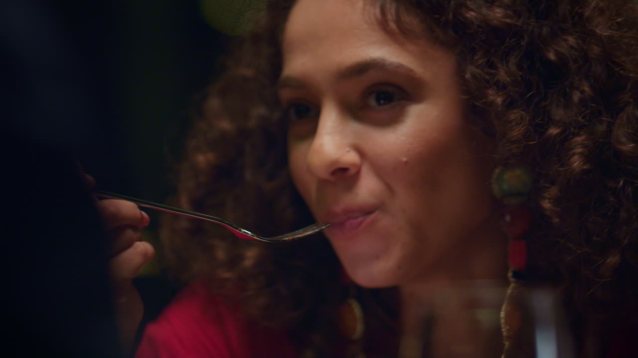 African american woman eating enjoying delicious dessert culinary in restaurant.