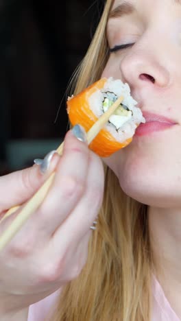 woman eating with chopsticks