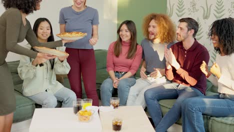 woman arriving with take away pizzas at home with friends