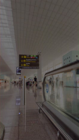 passengers walking in airport terminal in vertical