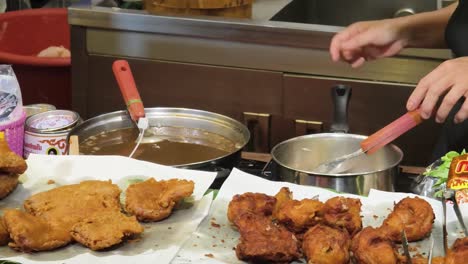 street food vendor preparing fried chicken
