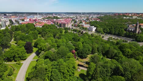 scenic view of swedish landscape at the slottskogen park and linne neighbourhood in central gothenburg, sweden - aerial drone, pullback shot