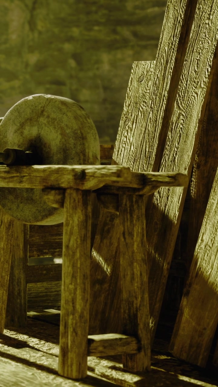 Gammel træstol med et stenhjul stående i et tomt rum