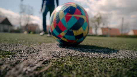 a young boy pass the ball through the field