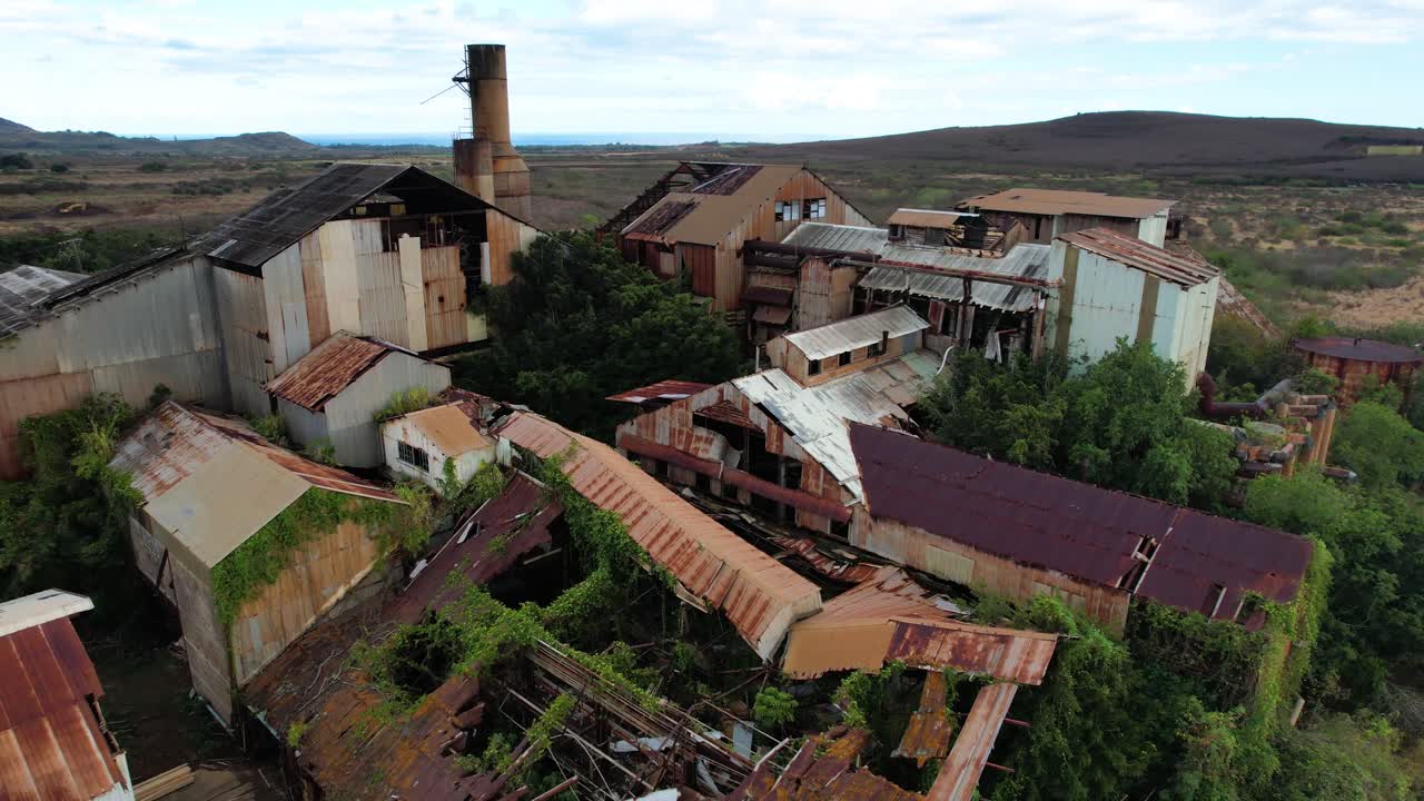 zoom in of dilapidated roof tops of koloa sugar mill, drone footage
