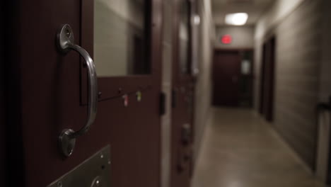 prison facility hallway with prison cell doors