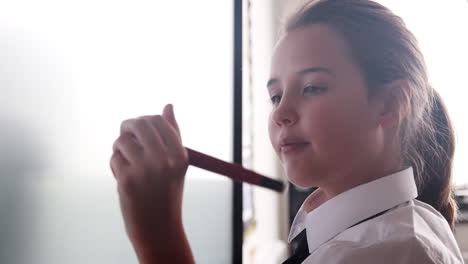 Female-High-School-Student-Wearing-Uniform-Using-Interactive-Whiteboard-During-Lesson