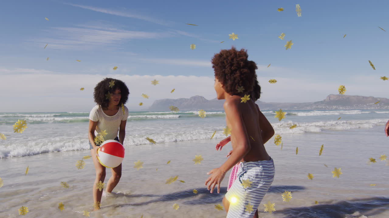 Animazione di coriandoli natalizi su bambini afroamericani in spiaggia
