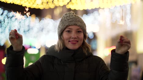 woman celebrating with sparkler at night