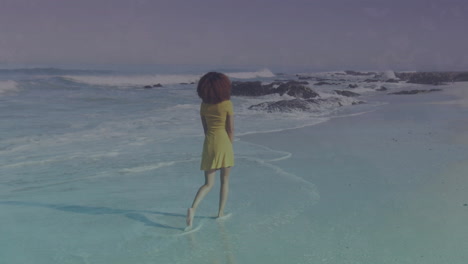walking on beach, woman in yellow dress over ocean waves animation