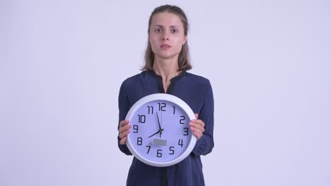 young beautiful businesswoman with wall clock