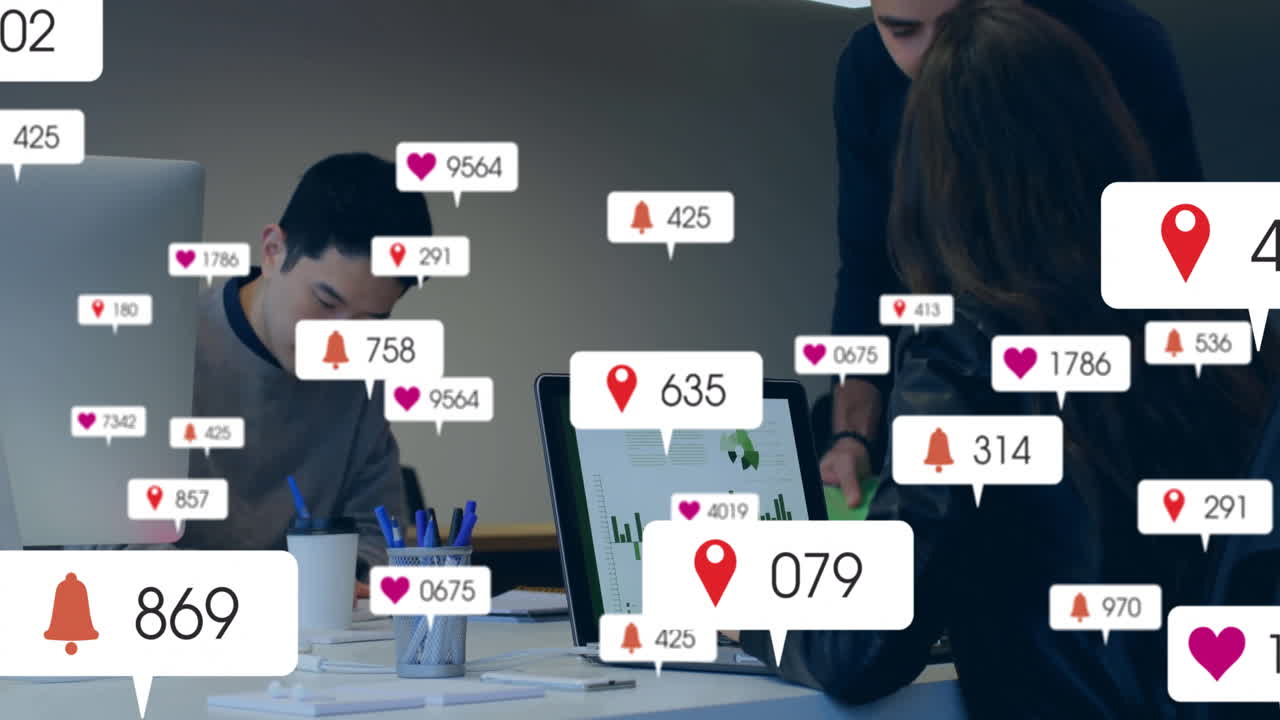 Three team members working around desk in business office displaying charts, floating alert icons