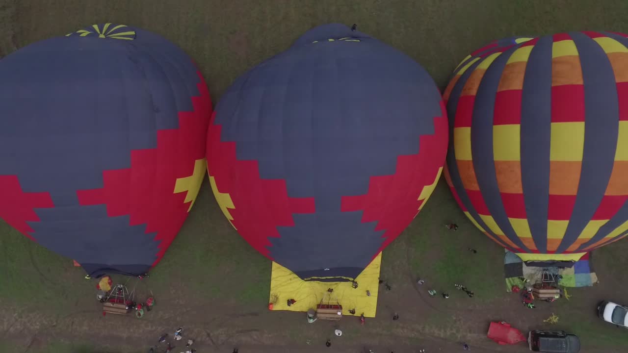 Hot air balloons on the ground.