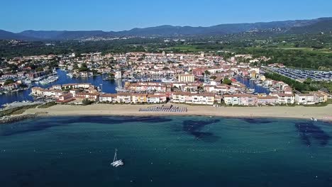 tranquil blue mediterranean ocean water, deserted beach scene, port background