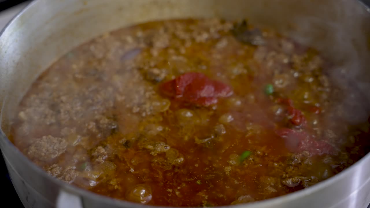 Sizzling Curry Sauce With Chopped Beef With Steam Vapour Rising. Slow Motion Shot