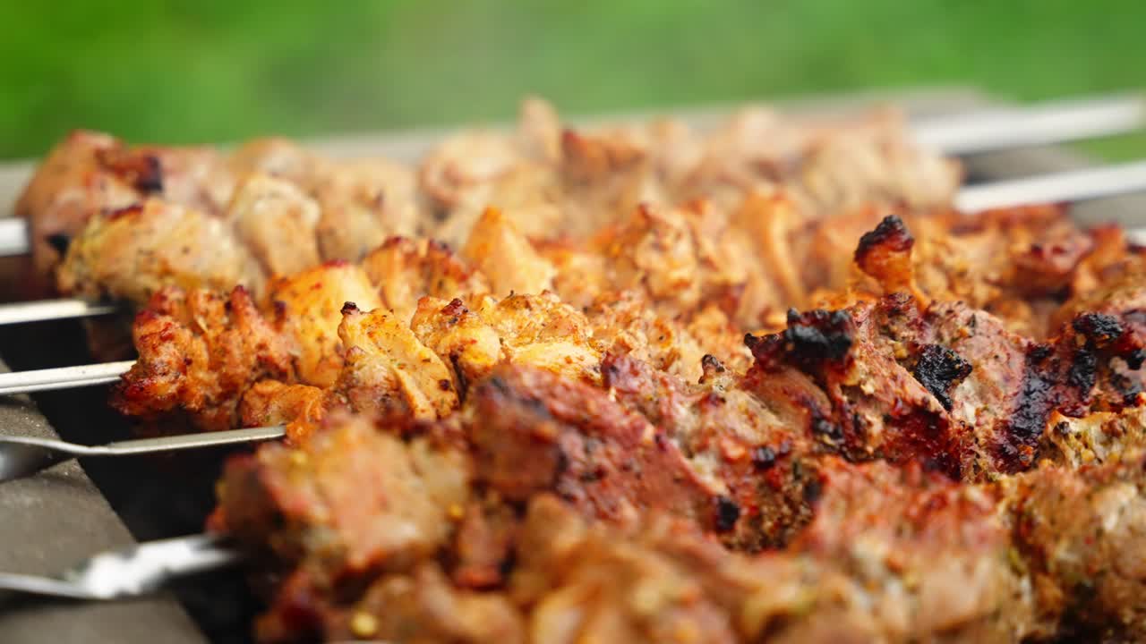 Juicy shashlik grilling outdoors on skewers, creating a savory atmosphere