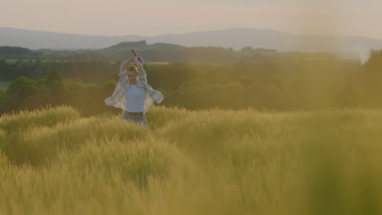 Happy Woman Running Through Fields During Sunset