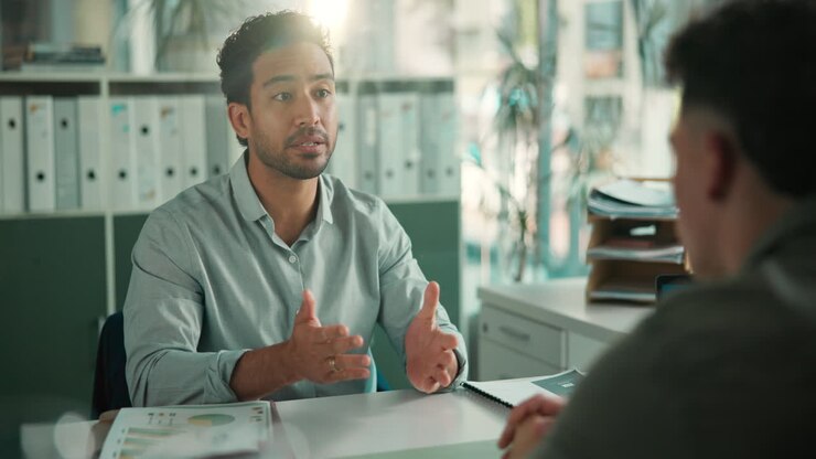 Professional Man Talking and Gesturing During an Office Meeting