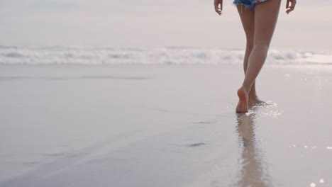 close up woman feet walking barefoot on beach enjoying gentle wet sea sand female tourist on summer vacation