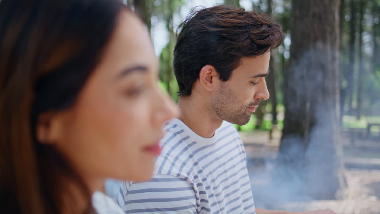 Smiling couple enjoying friendly conversation in park surrounded nature closeup