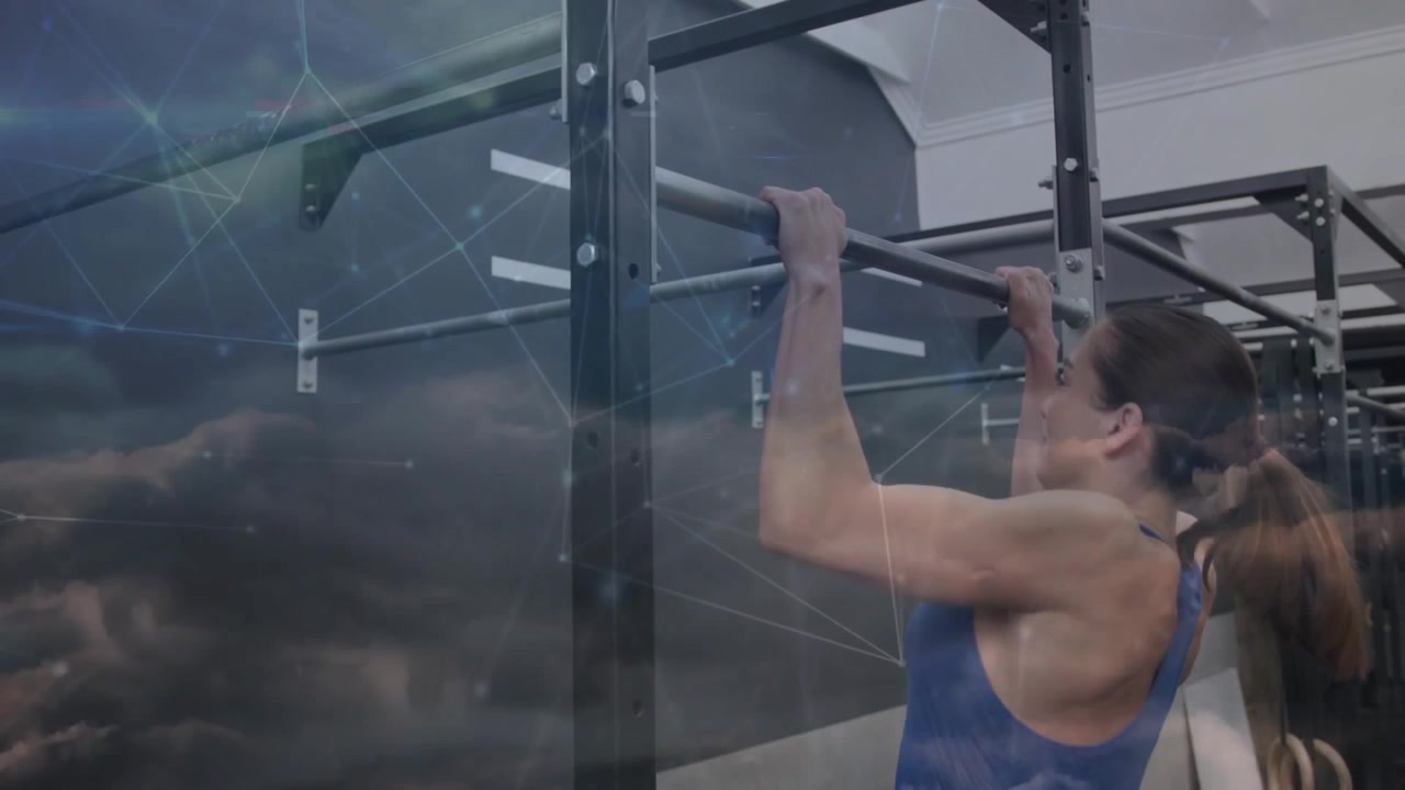 Woman gripping pull-up bar with hand entering, in gym, cloud overlay showing pulling for fitness