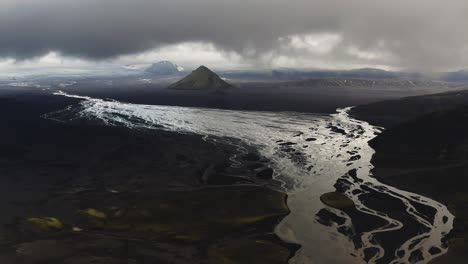 maelifellssandur river with view of maelifell volcano on cloudy day in iceland