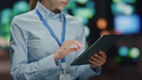 focused it woman working pad computer datacenter closeup. system administrator