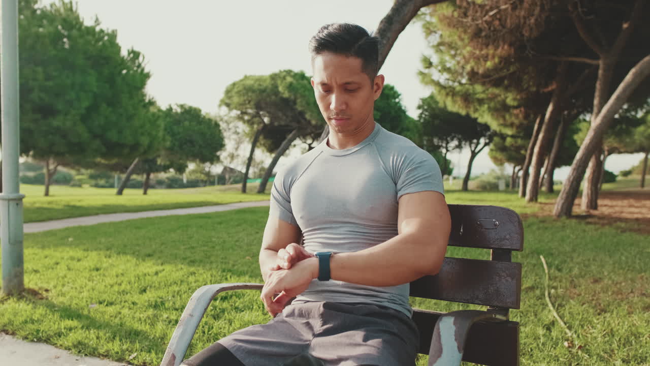 Man using a smartwatch in a park
