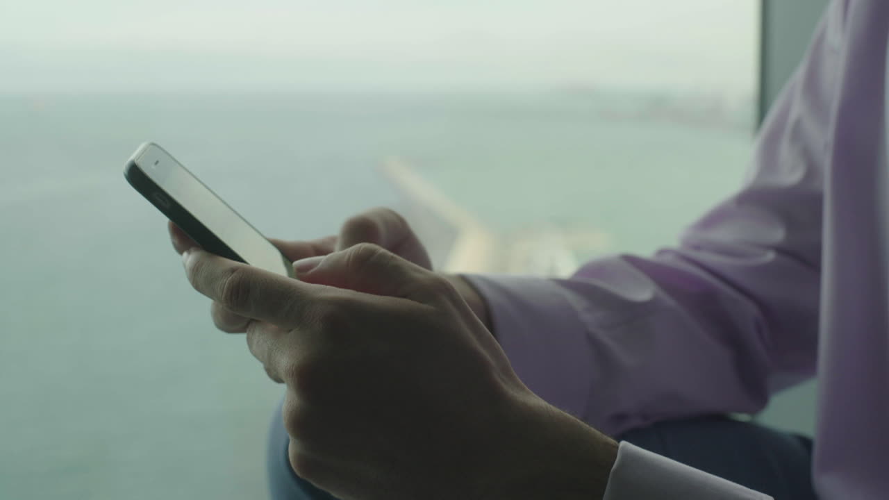 Man using smartphone with city view