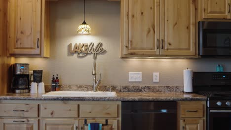 lake-life-sign-in-a-wooden-cabin-kitchen-above-the-sink