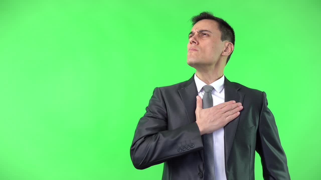 A man in a suit showing various emotions and gestures on a green screen