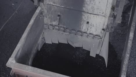 pouring iron coal on freight wagon for transporting