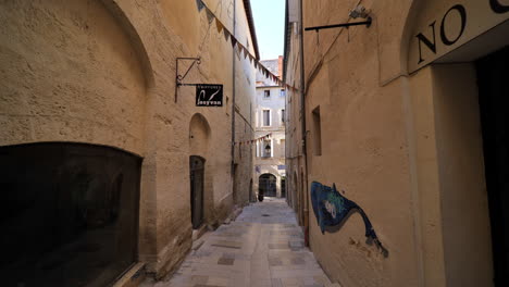 Typical-narrow-street-in-city-center-Montpellier-limestone-buildings-France