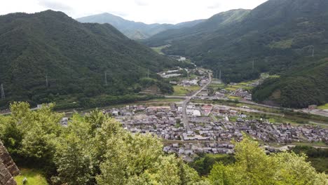 sprawling panoramic overview of asago valley, japanese village on overcast day