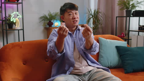 rich happy asian man showing wasting or throwing money around hand gesture profit win lottery share