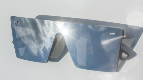 mirrored sunglasses reflecting clouds