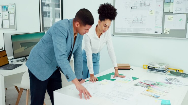Man, woman and fist bump in architecture blueprint