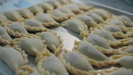 raw pierogi on a baking sheet