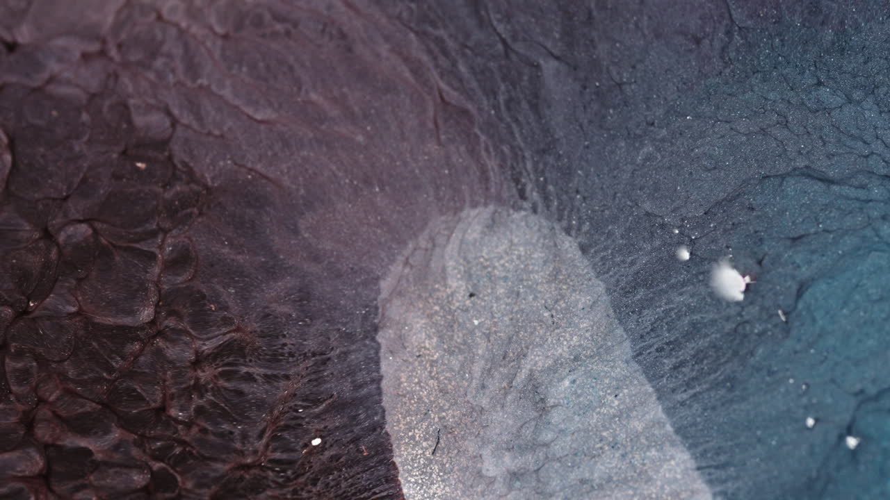 Swirling liquids create mesmerizing patterns in this macro view of fluid dynamics